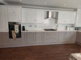 PB Decor – Painting and Decorating in Dublin featuring a bright white modern kitchen with wooden floors and painted cabinetry.